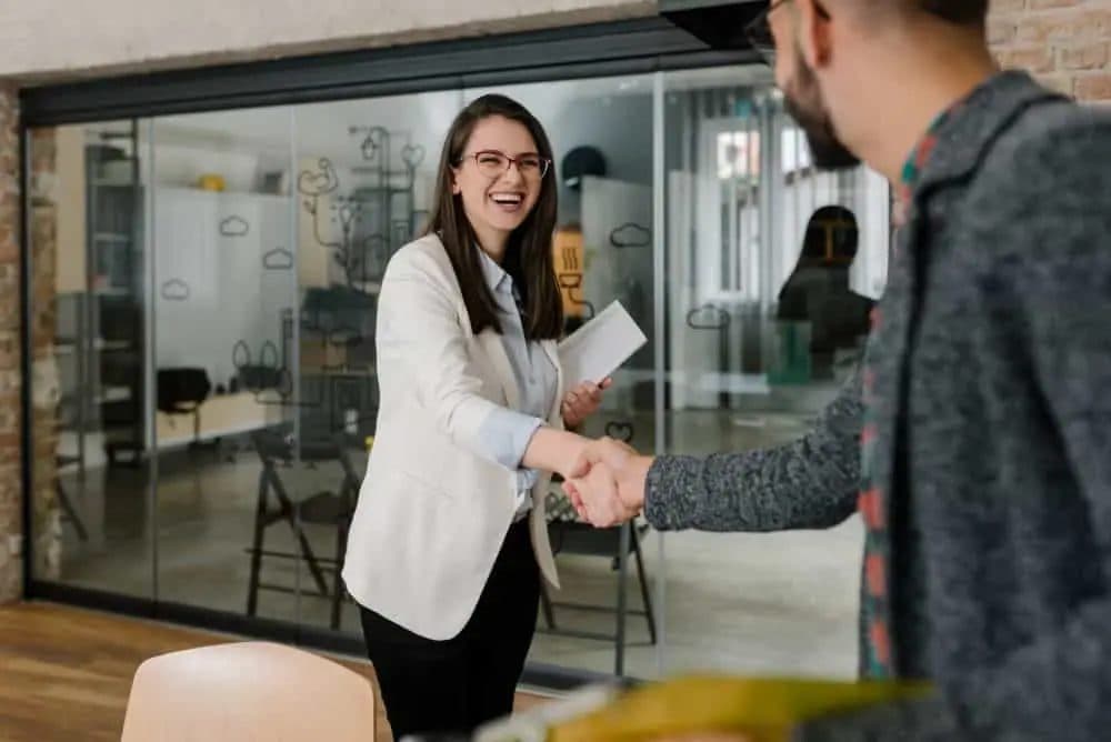 A welcoming handshake in a modern office